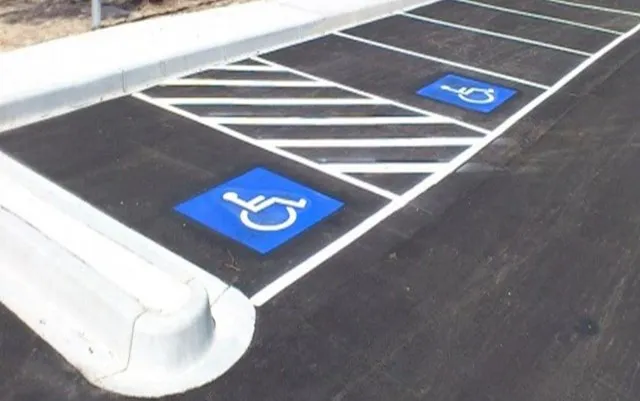 Completed tarmac car park with white line markings and disability parking bays